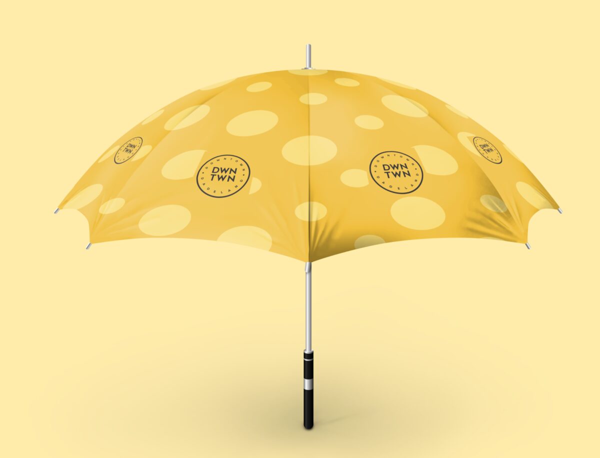 Yellow DWNTWN umbrella with a soft dot pattern