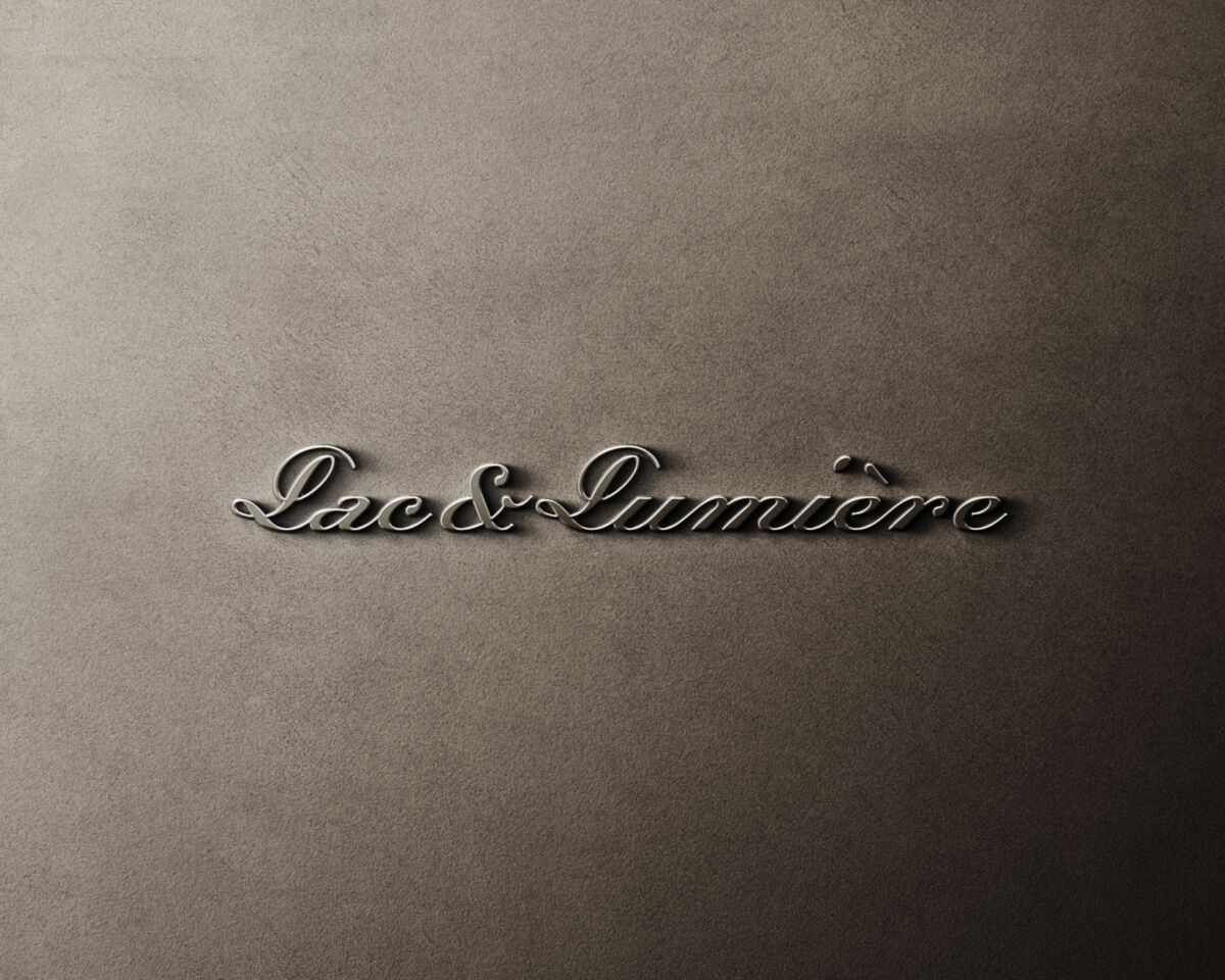 Lac & Lumière script logo embossed on grey paper