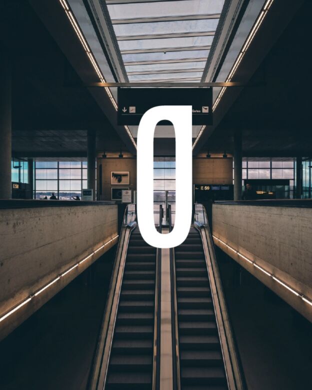 Large O letterform over an escalator